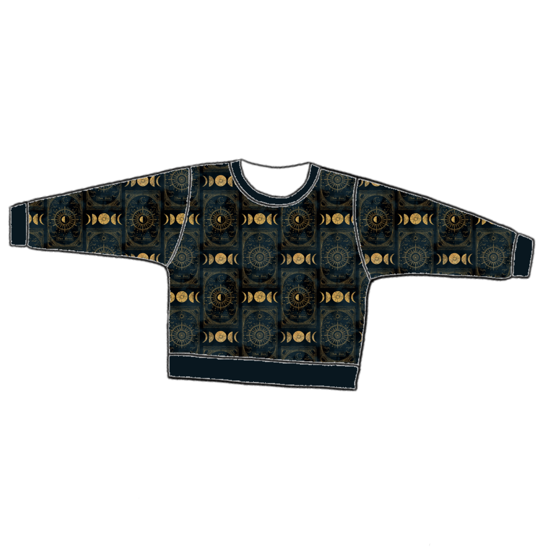 Handmade lounge sweater in Tarot – black and gold celestial jersey with moons, stars and suns, finished with ribbed neckline, cuffs and hem.
