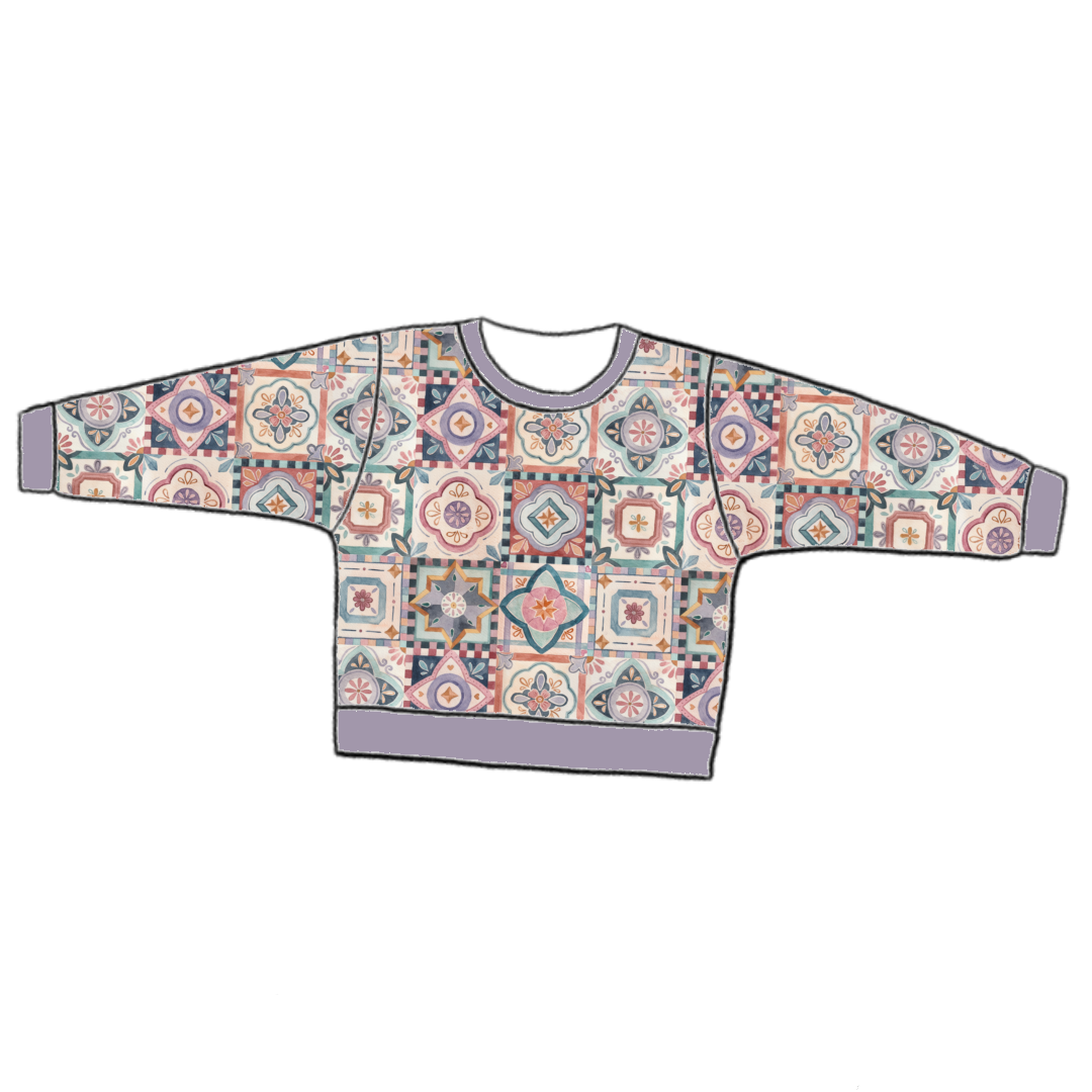 Handmade lounge sweater in Faro – warm tile-style jersey in terracotta, blush and navy with ribbed cuffs and waistband.
