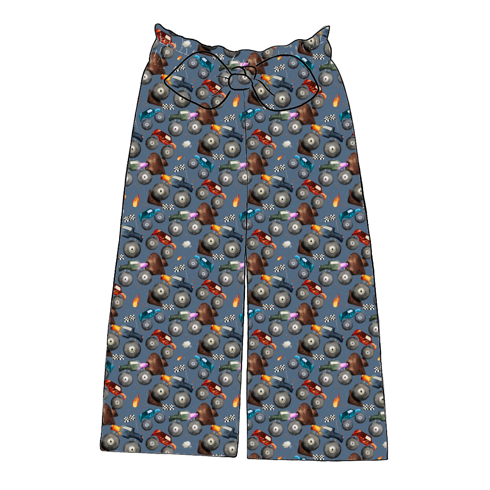 Handmade paperbag trousers in Monster Trucks – blue fabric with monster trucks, flames and flags, wide leg with bow waistband.
