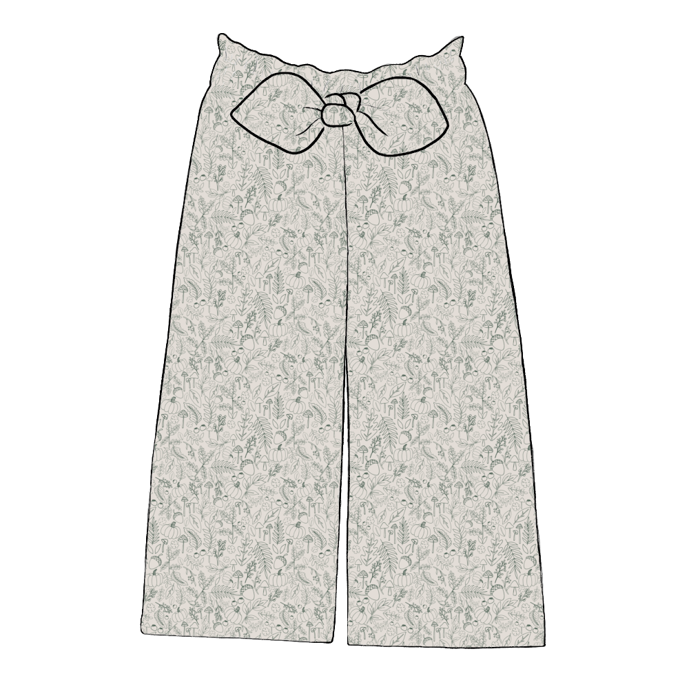 Paperbag style kids’ trousers in Autumn Outlines – soft jersey with fine green foliage and pumpkin sketches on a neutral background.