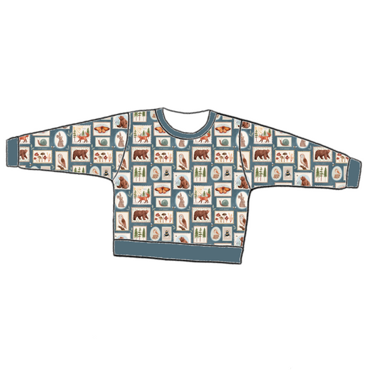 Handmade lounge sweater in Wild Stamps – dusky jersey with woodland tile motifs in rust, blue and cream, with ribbed cuffs and hem.