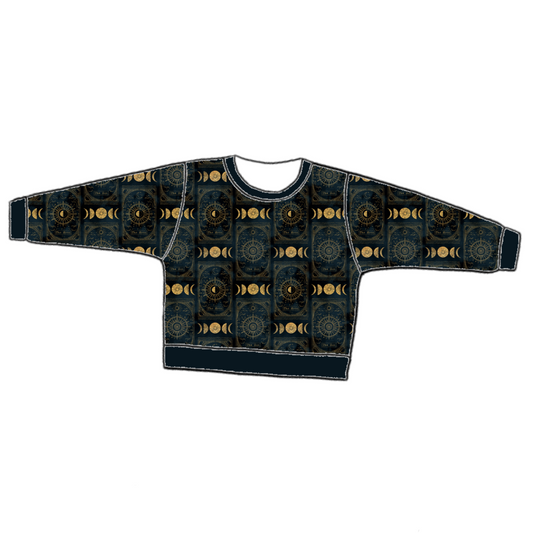 Handmade lounge sweater in Tarot – black and gold celestial jersey with moons, stars and suns, finished with ribbed neckline, cuffs and hem.