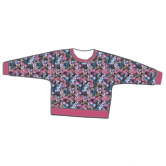 Handmade lounge sweater in Matilda Floral – bold blue jersey with painterly florals in fuchsia, violet and green, finished with ribbed cuffs and hem.