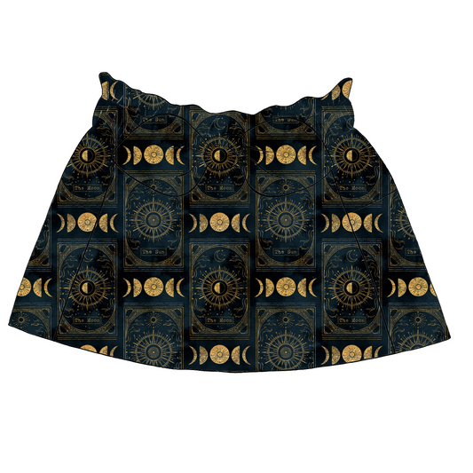 Children’s paperbag skirt in Tarot fabric – navy base with golden sun and moon tarot cards and celestial motifs, with bow and pockets.