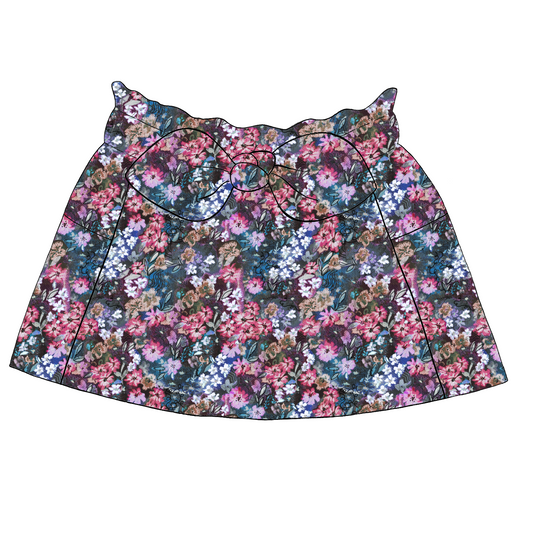 Children’s paperbag skirt in Matilda fabric – navy base with hand-painted florals in pink, blue and lilac, finished with bow and pockets.