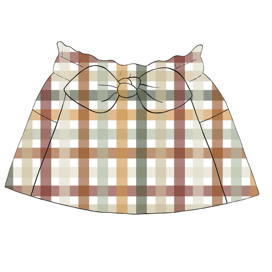 Children’s paperbag skirt in Harvest Gingham – warm-toned check in rust, mustard, sage and cream with bow tie waist and deep pockets.