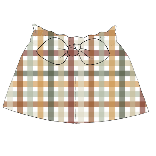 Children’s paperbag shorts in Harvest Gingham – rust, mustard, sage and cream gingham with ruffle waistband and bow detail.