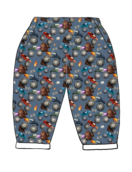 Handmade children's trousers in Monster Trucks – bold blue print with monster trucks, flames and racing flags, finished with pockets and rolled hems.