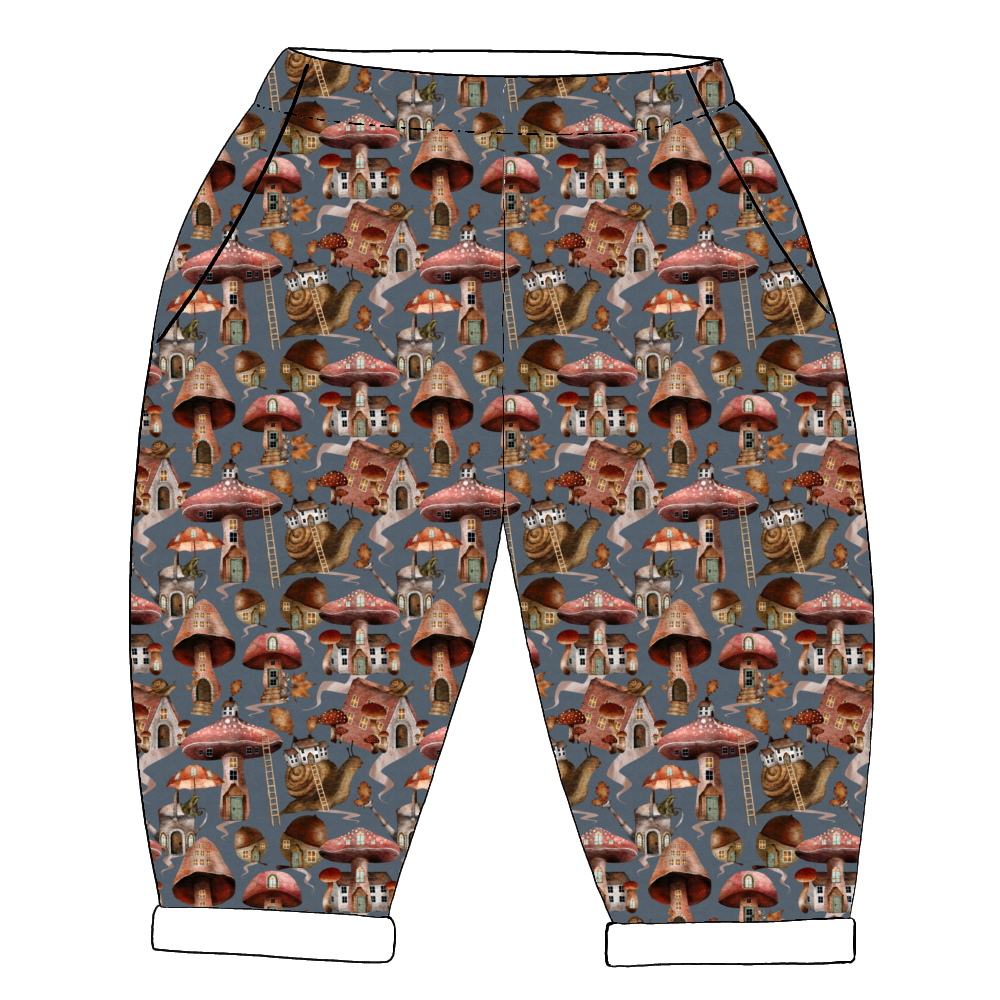 Whimsical handmade trousers in Mushroom Town – mushroom houses and snails on blue-grey jersey, with rolled hems and pockets.