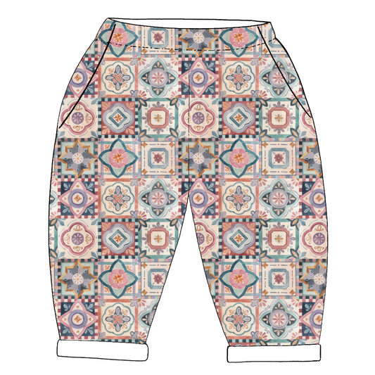 Handmade children’s vintage pocket trousers in Faro – patterned tile print in warm autumnal tones with rolled hems and roomy side pockets.