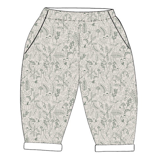 Children’s handmade trousers in Autumn Outlines – green line-drawn leaves on neutral base with elasticated waist and pockets.
