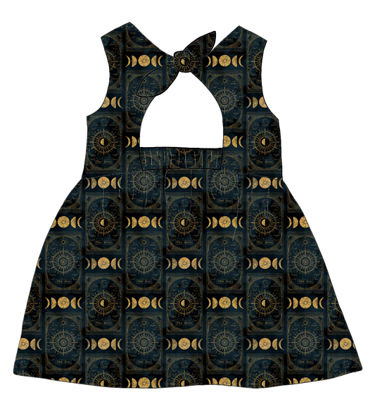 Bow Back Dress in Tarot – celestial print jersey in black and gold featuring stars, moons and suns. Finished with a lined bodice and bow tie back.