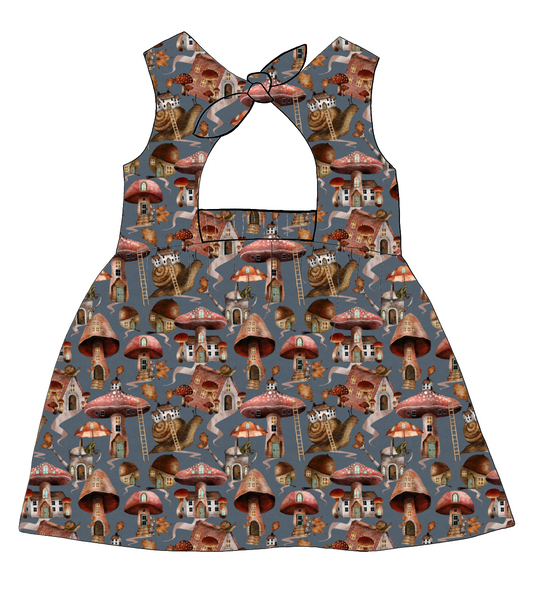 Bow Back Dress in Mushroom Town – soft blue-grey jersey with mushroom houses, snails and toadstools. Lined bodice and playful bow at the back.