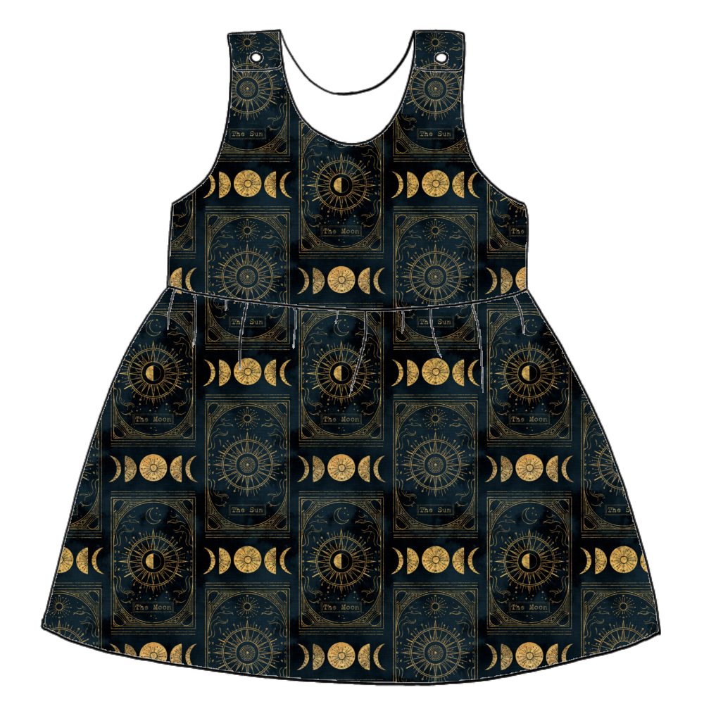 Handmade pinafore dress in Tarot – celestial jersey with black and gold tarot motifs including moons, stars and suns. Features popper straps and gathered skirt.