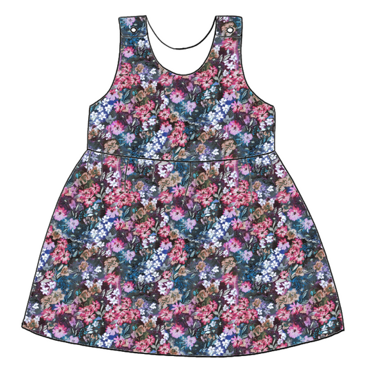 Handmade pinafore dress in Matilda Floral – deep blue jersey with layered painterly florals in fuchsia, violet and green. Features popper fastening straps.