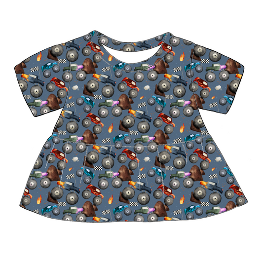 Handmade short sleeved peplum top in Monster Trucks – blue jersey with colourful trucks, flames and racing flags. 