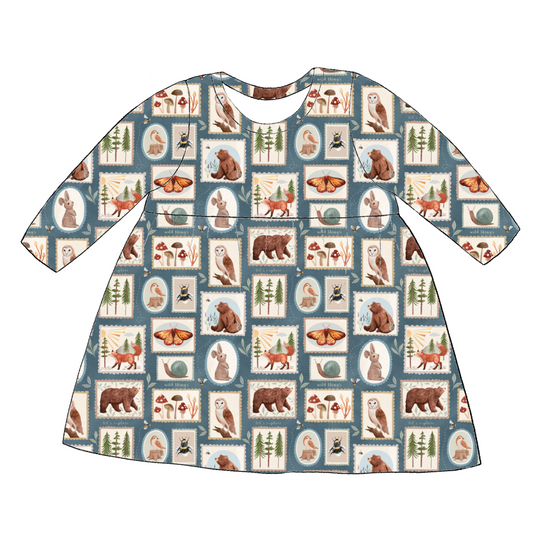 Long sleeve handmade gathered dress in Wild Stamps – jersey with woodland tile print in dusky blue and rust tones.
