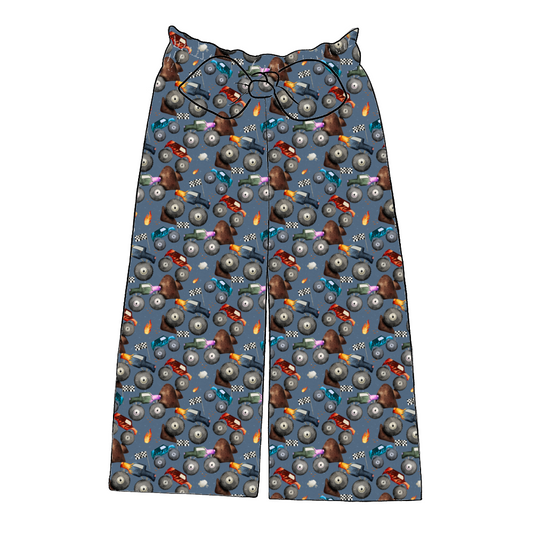 Handmade paperbag trousers in Monster Trucks – blue fabric with monster trucks, flames and flags, wide leg with bow waistband.