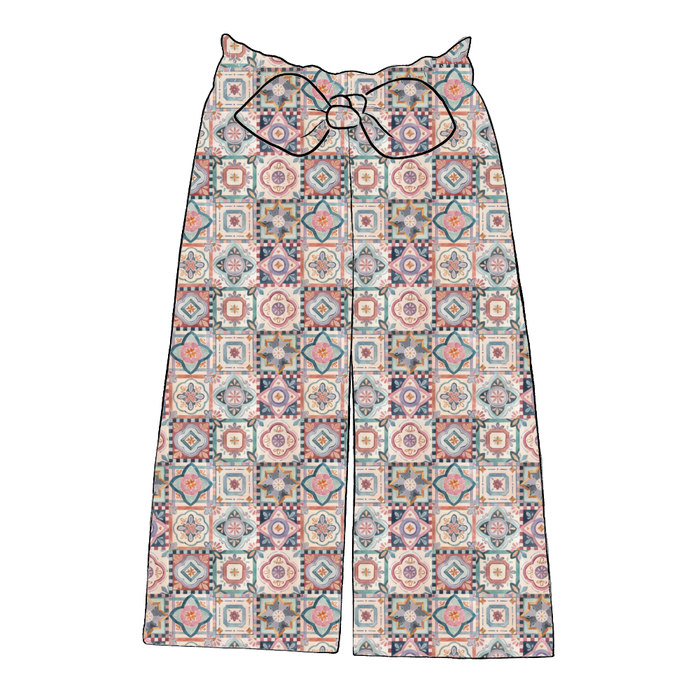 Children’s wide leg paperbag trousers in Faro – colourful tile print with elasticated waist and statement bow.