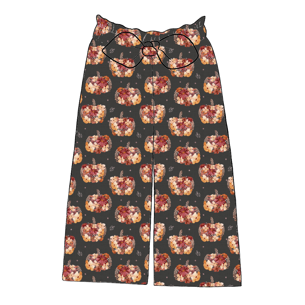Children’s wide leg paperbag trousers in Baize – charcoal jersey with painterly pumpkins and autumn florals, finished with elastic waist and bow.