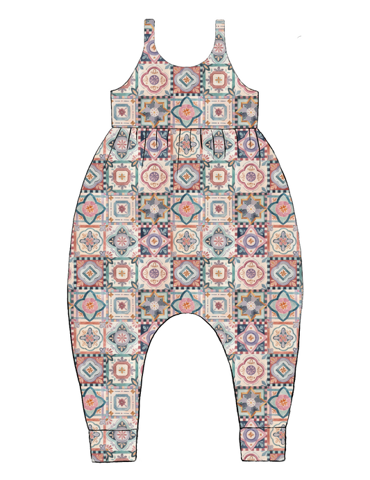 Handmade Napa Romper in Faro – tile-style print with terracotta, blush, navy and green on soft jersey. Harem-style legs and pull-on straps.