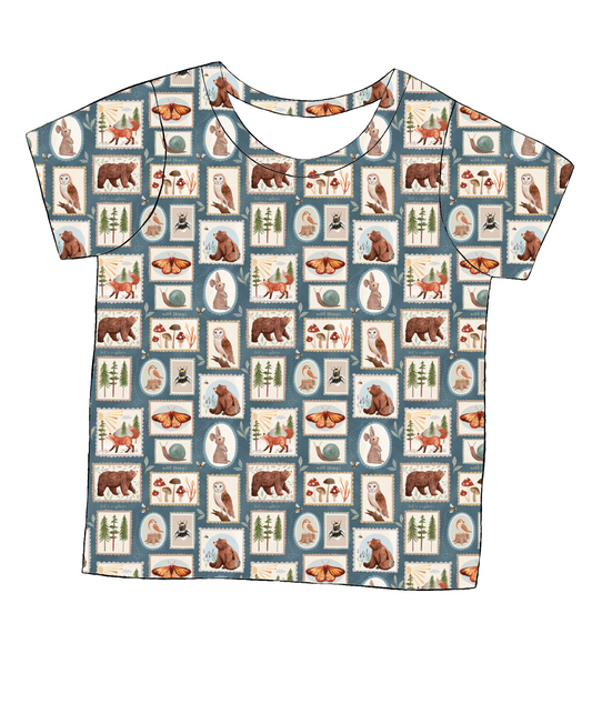 Short sleeve handmade T-shirt in Wild Stamps – soft jersey with folk-style woodland tile print in muted tones.
