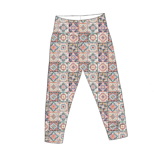 Baby leggings in Faro – colourful tile-style pattern in terracotta, navy and blush with wide waistband and cuffed ankles.