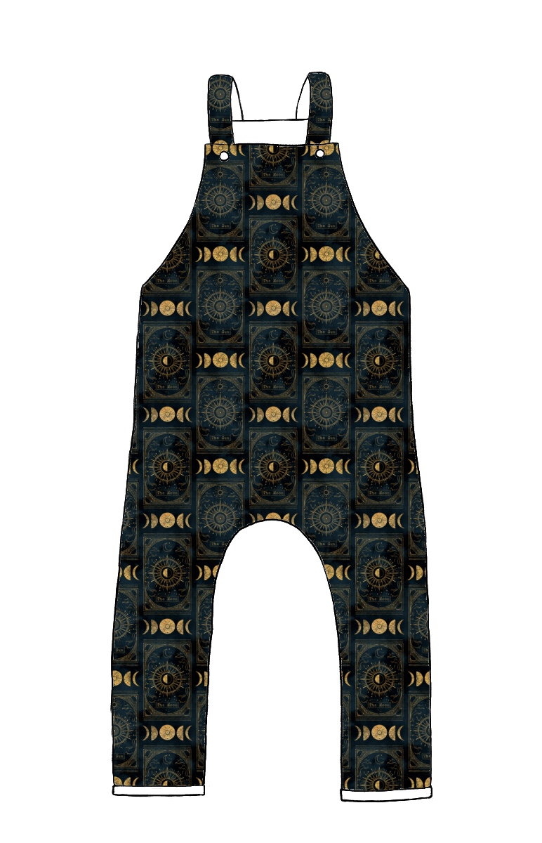 Full-length handmade dungarees in Tarot – dark jersey with celestial suns, moons and stars in golden tones, finished with rolled hems.