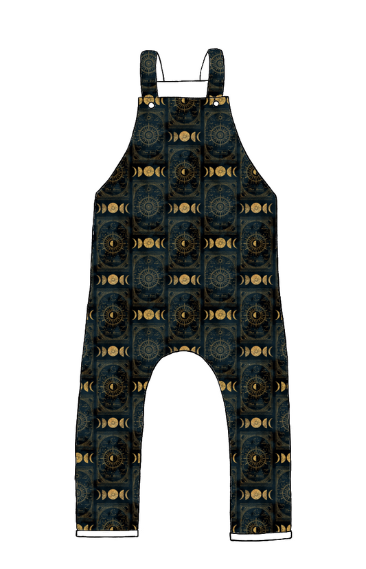 Full-length handmade dungarees in Tarot – dark jersey with celestial suns, moons and stars in golden tones, finished with rolled hems.