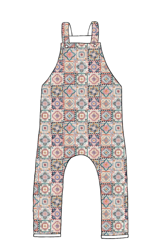 Full-length handmade dungarees in Faro – ornate tile-style pattern in warm muted colours of terracotta, navy and blush.