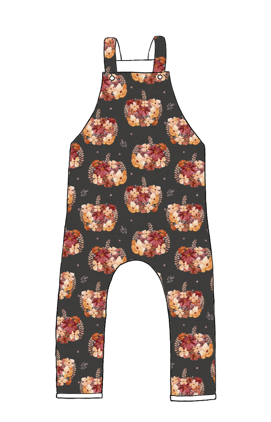 Children’s dungarees in Baize fabric – charcoal background with floral pumpkins in peach, rust and burgundy, finished with a rolled hem.