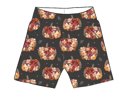 Charcoal-coloured pocket shorts for children featuring scattered floral pumpkins in autumn colours.