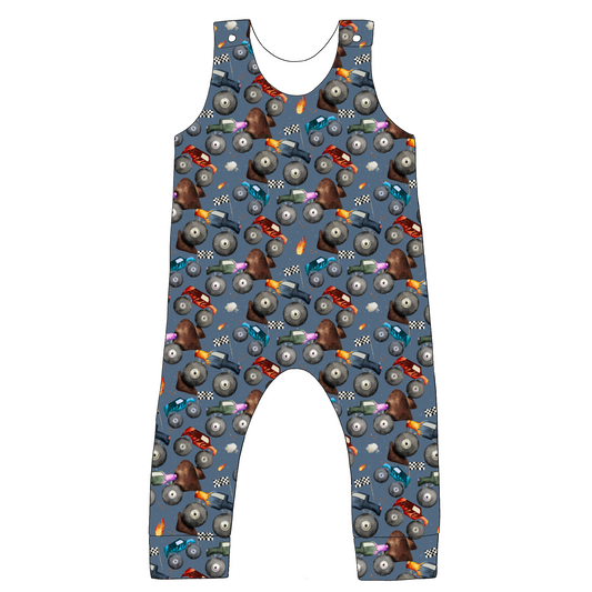 Full-length handmade dungarees in Monster Trucks – blue jersey with monster trucks, flames and flags, finished with rolled hems and comfy straps.
